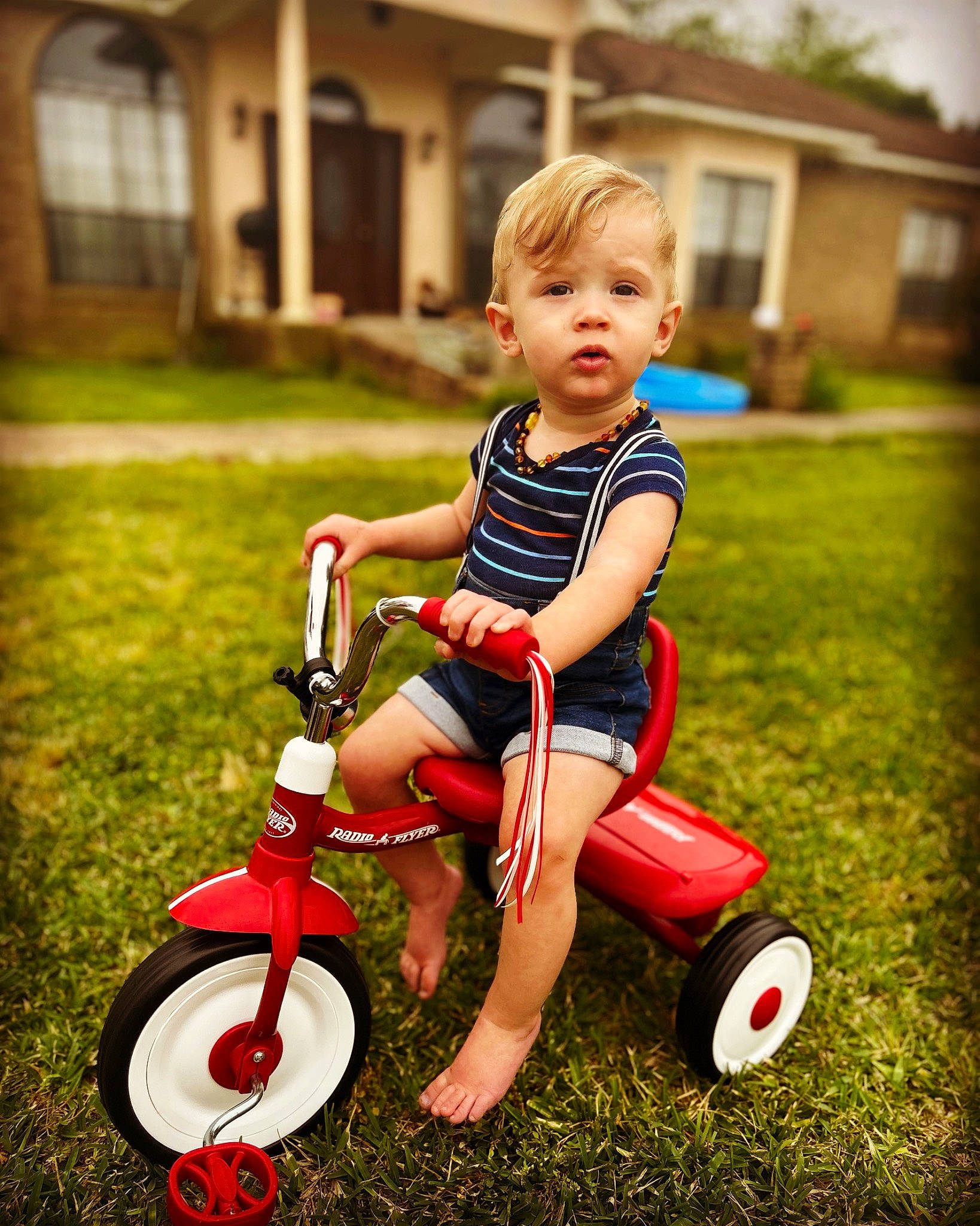 Aiden is registered to the contest to win money with this photo: baby, baby_toddler_clothing, bicycle, bicycle_accessory, child, flash_photography, fun, grass, happy, lawn, leisure, people_in_nature, person, plant, recreation, riding_toy, tire, toddler, vehicle, wheel