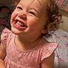 toddler, child, smiling, tiara, pink_dress, curly_hair, toy, bed, unicorn, happy, indoor, cute, face, person, playful, young_child, bedroom, furniture, girl, joyful