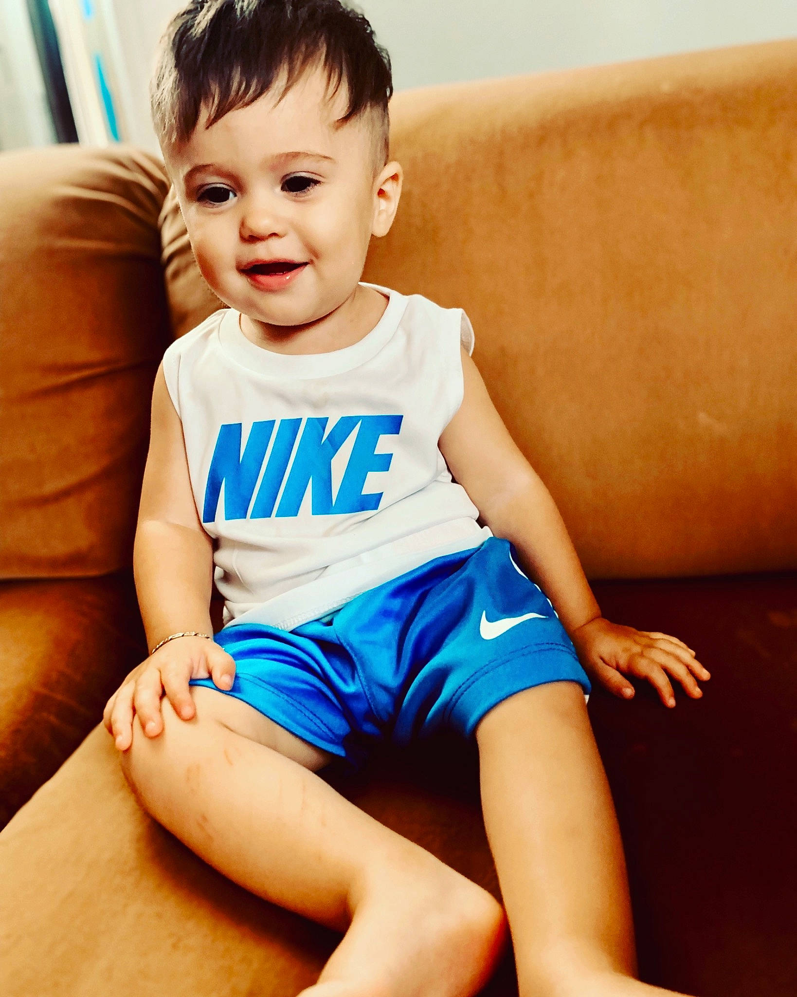 Alessio is registered to the contest to win money with this photo: baby_toddler_clothing, blue, child, child_model, clothing, leg, person, sitting, smile, toddler