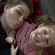 Octavia is registered to the contest to win money with this photo: casual, child, closeup, face, family, floor, hair, hand, happy, hoodie, indoor, pink_clothing, portrait, pout, red_blanket, selfie, skin, smile, toddler, woman