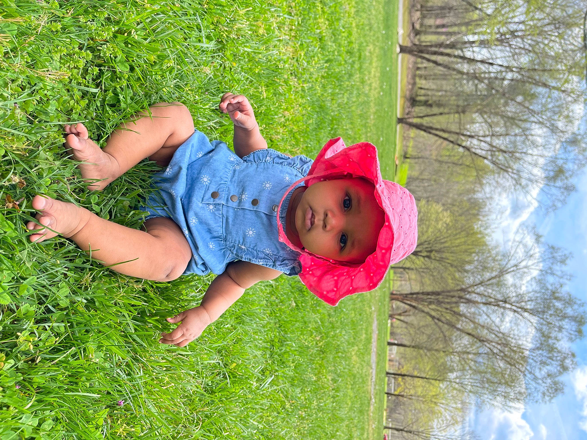 Emery is registered to the contest to win money with this photo: baby, baby_toddler_clothing, child, cloud, fun, grass, grassland, happy, hat, headwear, landscape, lawn, leisure, people_in_nature, person, plant, recreation, sky, sun_hat, toddler