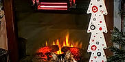 Baby joined the competition — help win amazing prizes! cat, christmas_decorations, cozy, decorative_tree, festive, fireplace, flooring, gift_box, holiday, indoor, living_room, ornament, pet, plush, santa_figurine, seasonal, snowman_figurine, tinsel, warm_lighting, wood_floor