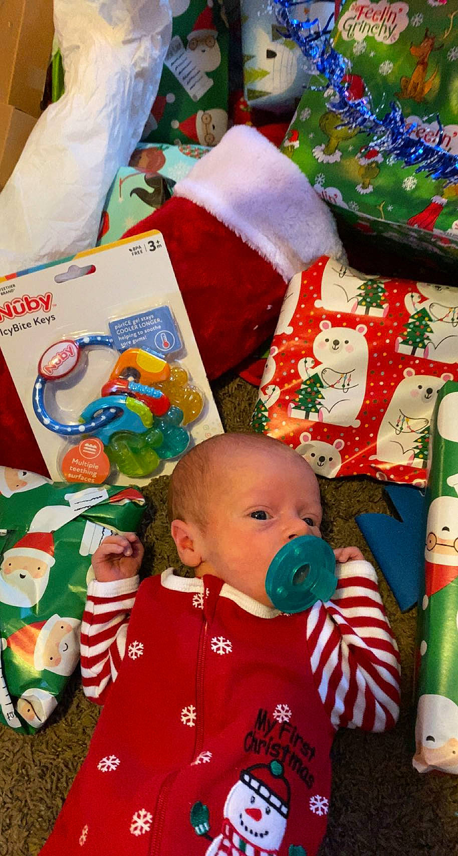 Kipp is registered to the contest to win money with this photo: art, baby, baby_products, baby_toddler_clothing, carmine, child, christmas, christmas_eve, event, fictional_character, green, happy, holiday, linens, person, product, red, room, textile, toddler