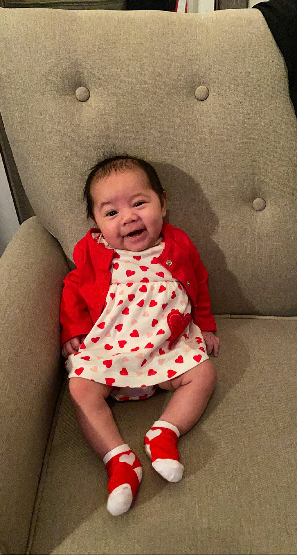 Kylani is registered to the contest to win money with this photo: arm, baby, baby_toddler_clothing, cheek, comfort, dress, eye, face, finger, flash_photography, happy, leg, neck, person, pink, skin, sleeve, smile, sock, toddler