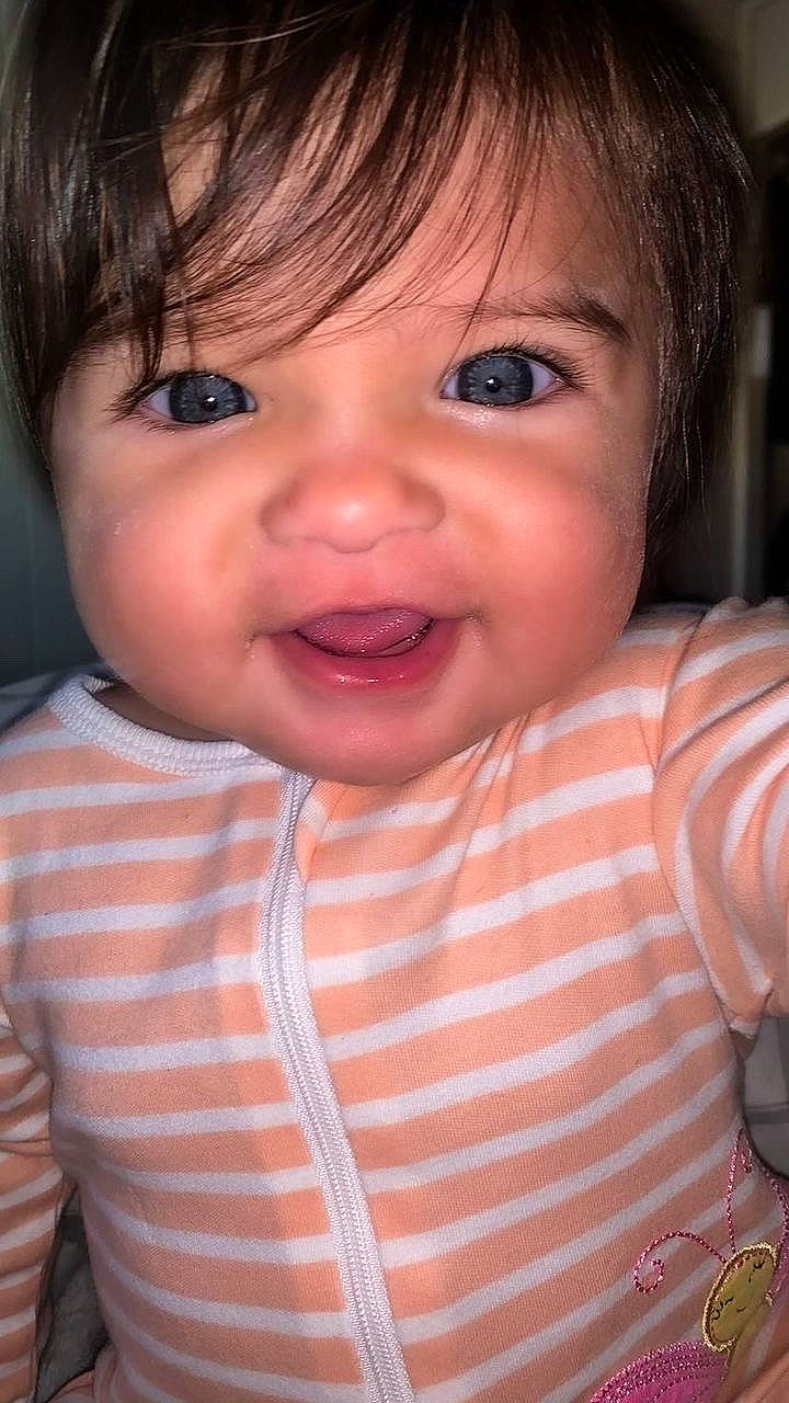 Skylar is registered to the contest to win money with this photo: baby, cheek, chin, ear, eyebrow, eyelash, forehead, gesture, happy, human_body, iris, lip, mouth, neck, nose, person, product, skin, sleeve, smile