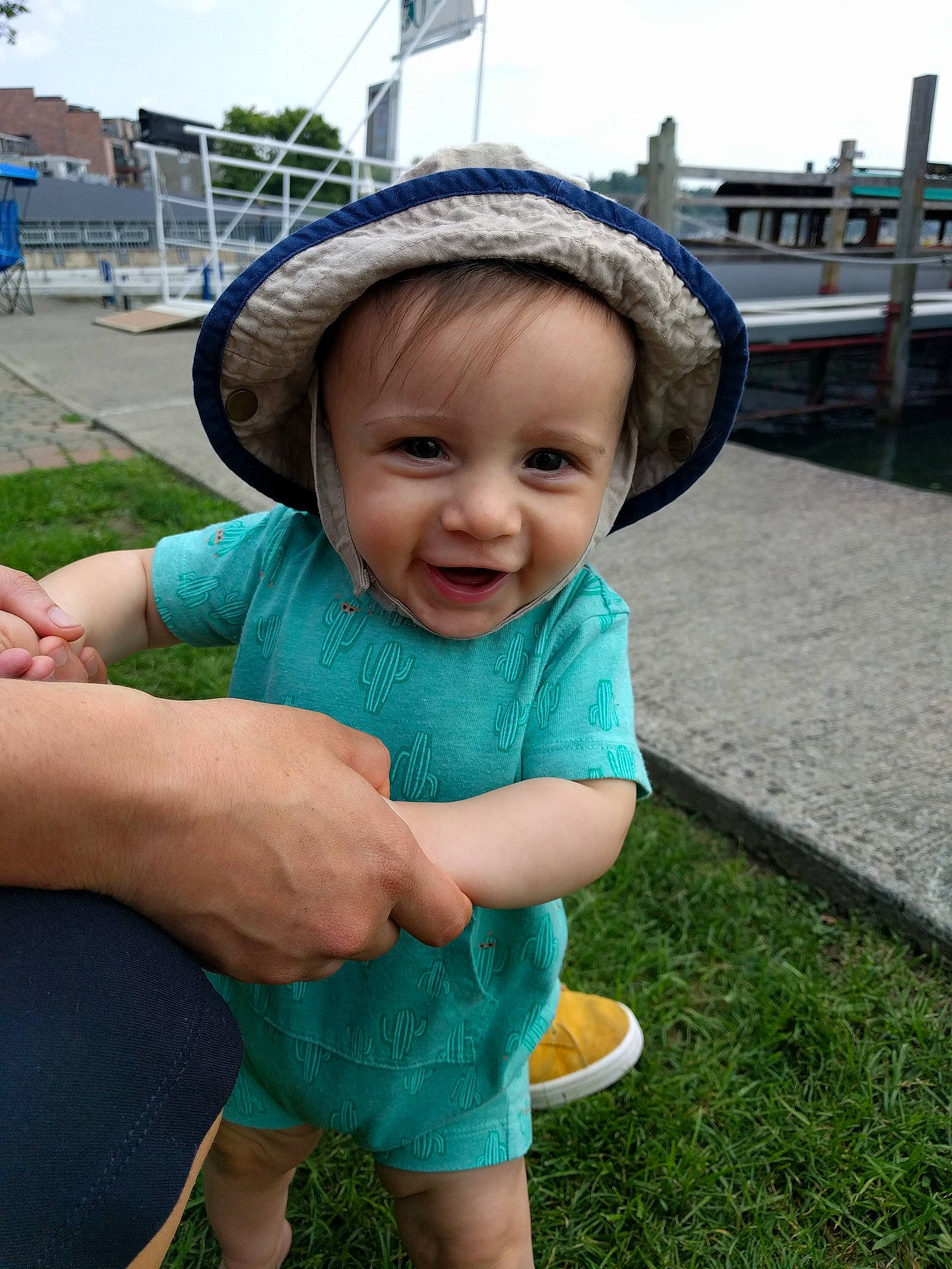 Reid is registered to the contest to win money with this photo: arm, child, cool, fun, girl, grass, green, hand, happiness, hat, headgear, infant, lawn, person, play, product, skin, smile, summer, toddler