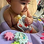 Jeannette joined the competition — help win amazing prizes! baby, child, face, food, salmon, pouch, purple, toy, gears, activity_chair, cute, eating, messy, indoors, infant, person, skin, hand, earring, closeup