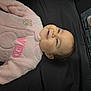 Jeannette joined the competition — help win amazing prizes! baby, child, smiling, pink_clothing, fuzzy, lying_down, face, head, earrings, black_background, text_label, fabric, cute, portrait, infant, soft_texture, happy, closeup, young, apparel