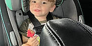 Karson joined the competition — help win amazing prizes! child, toddler, car_seat, car_interior, smiling, cookie, snack, seatbelt, safety, hair, face, leather_seat, window, clothing, cup_holder, seat, seatbelt_strap, happy, young_child, inside_car