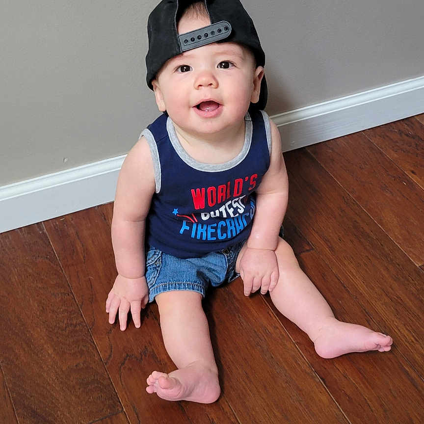Holden joined the competition — help win amazing prizes! baby, baseballcap, bodypart, cap, clothing, face, finger, hand, hardwood, hat, head, indoors, interiordesign, pants, person, photography, portrait, shorts, sitting, wood