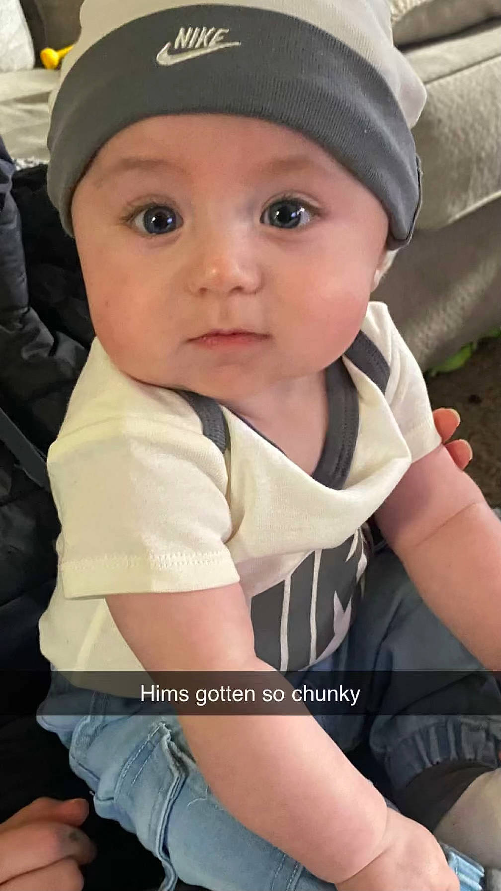 Oliver is registered to the contest to win money with this photo: baby, baby_toddler_clothing, cap, cheek, child, cool, elbow, eye, eyebrow, fashion_accessory, flash_photography, fun, gesture, happy, headwear, person, sitting, sleeve, thigh, thumb
