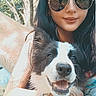 woman, dog, outdoor, nature, pet, smiling_dog, sunglasses, happy, trees, daylight, grass, animal, portrait, leash, black_and_white_dog, tattoo, person, casual_clothing, summer, friendship