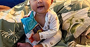 Paloma joined the competition — help win amazing prizes! baby, infant, child, toy, soft_toy, bed, pillow, blanket, indoor, person, cute, smiling, sitting, clothing, plush, decor, face, happy, portrait, room