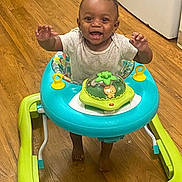 Jay R joined the competition — help win amazing prizes! baby, walker, child, smile, happy, indoors, floor, wooden_floor, toy, colorful, person, standing, playful, infant, cute, young_child, bright, cheerful, home, baby_walker