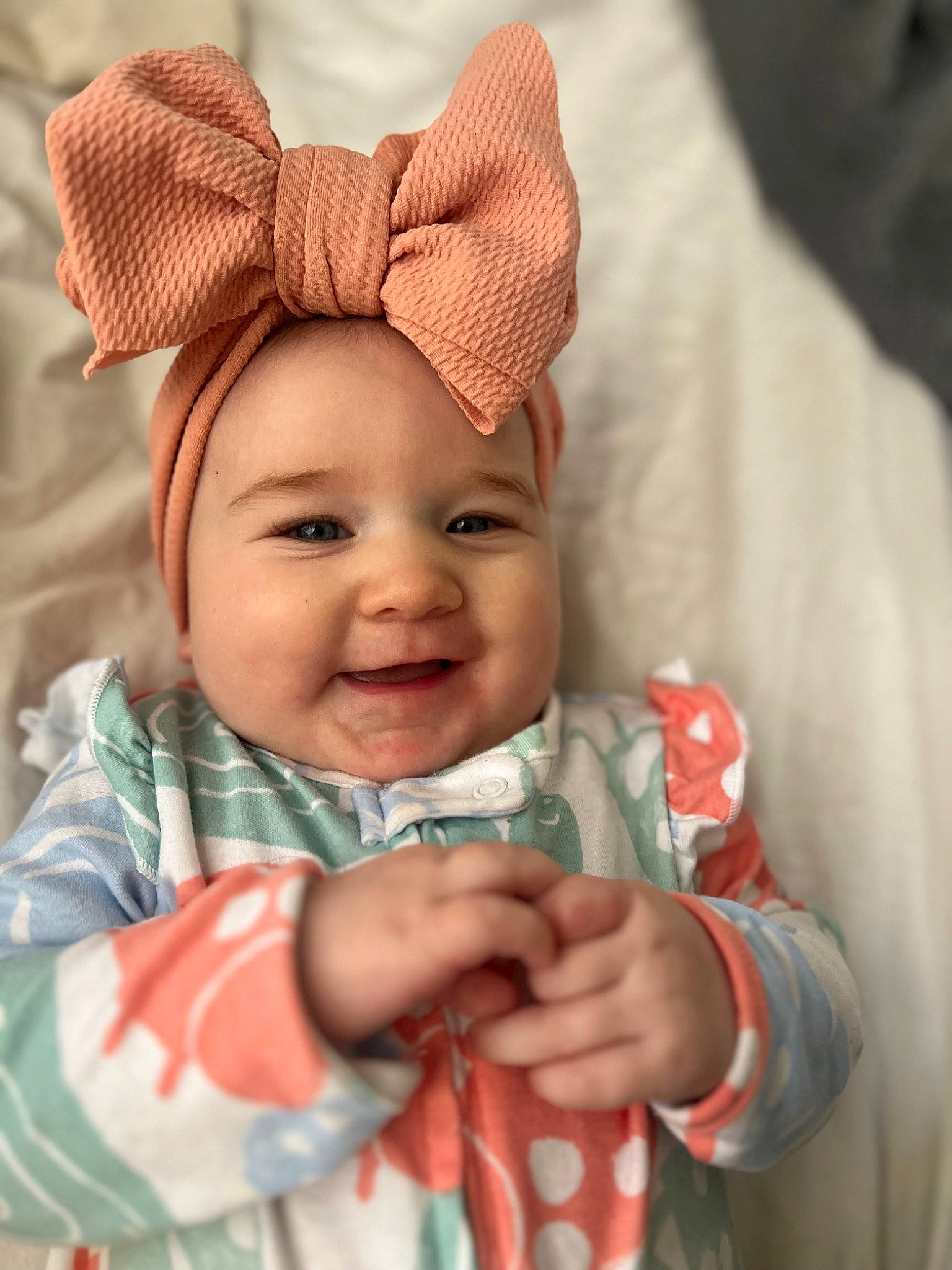 Aya is registered to the contest to win money with this photo: baby, baby_toddler_clothing, cheek, child, chin, cool, eye, eyebrow, face, facial_expression, finger, gesture, happy, head, headwear, joy, lip, person, pink, skin