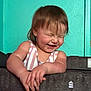 toddler, child, laughing, happy, face, hair, arm, hands, striped_clothing, tank_top, indoor, wall, turquoise, texture, playpen, infant, person, smile, joy, candid