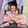 Emelia is registered to the contest to win money with this photo: baby, blanket, bottle, car_seat, child, clothing, feet, floor, footwear, infant, person, pink, portrait, resting, sitting, socks, stroller, toddler, young_child, indoor