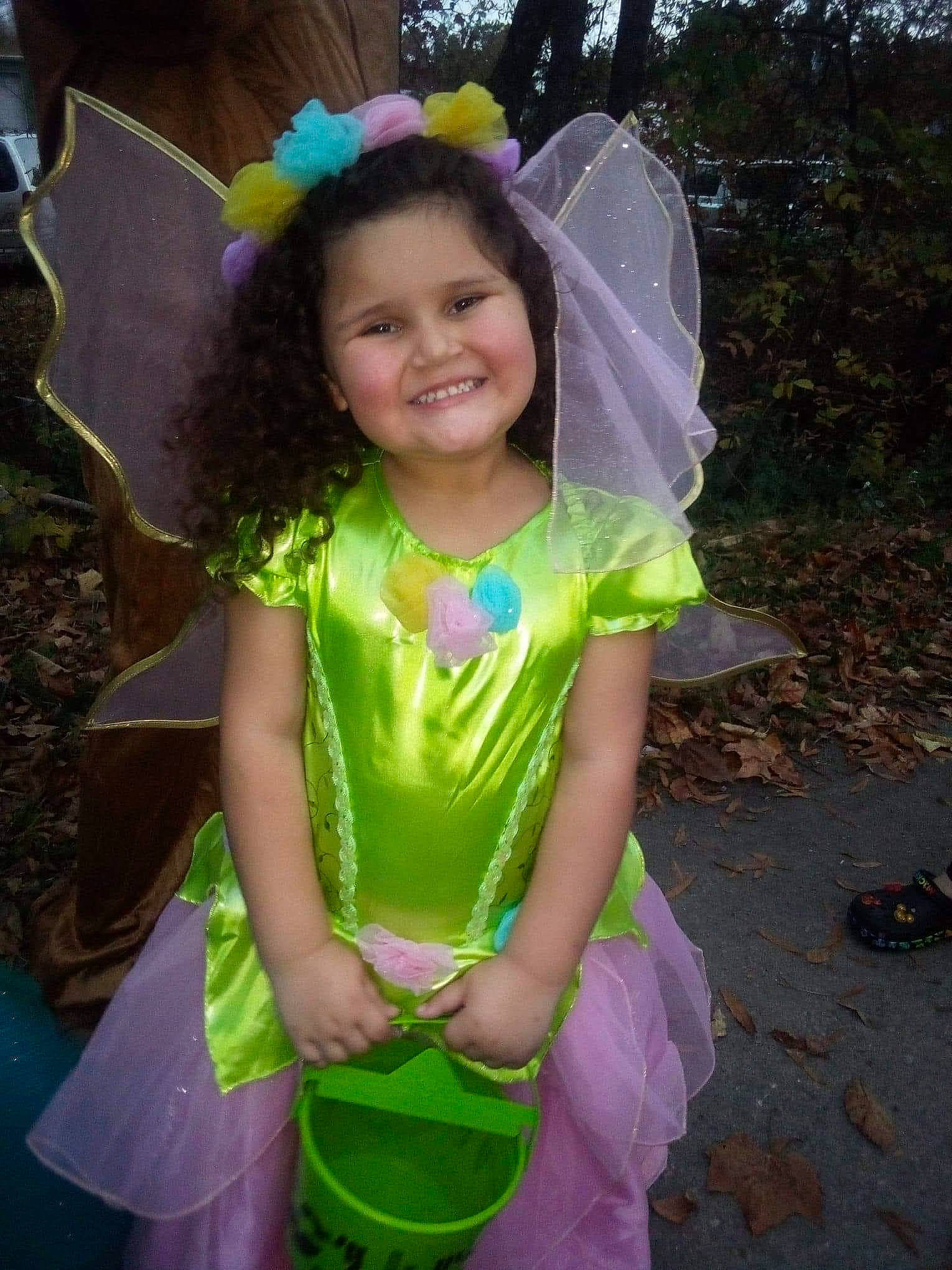 Jamie is registered to the contest to win money with this photo: baby_toddler_clothing, child, costume, costume_accessory, costume_hat, event, fashion_accessory, fun, grass, hair_accessory, happy, headpiece, joy, magenta, mythical_creature, party_supply, person, pink, purple, smile