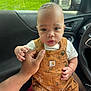Trulynn is registered to the contest to win money with this photo: baby, child, infant, car, window, raindrops, overalls, clothing, hand, lap, seat, interior, person, face, expression, cute, indoors, sitting, closeup, young