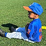 child, baseball, uniform, grass, outdoor, blue_cap, blue_shirt, white_pants, black_shoes, shadow, side_view, kneeling_adults, sunny, sports, field, young_boy, thinking, casual, team_sport, daylight