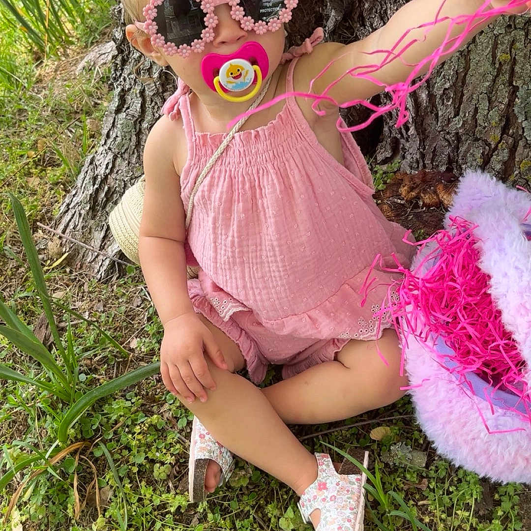 Zoey is registered to the contest to win money with this photo: child, clothing, costume, dress, face, female, flower, footwear, girl, grass, head, person, petal, photography, plant, portrait, purple, sandal, shoe, vegetation