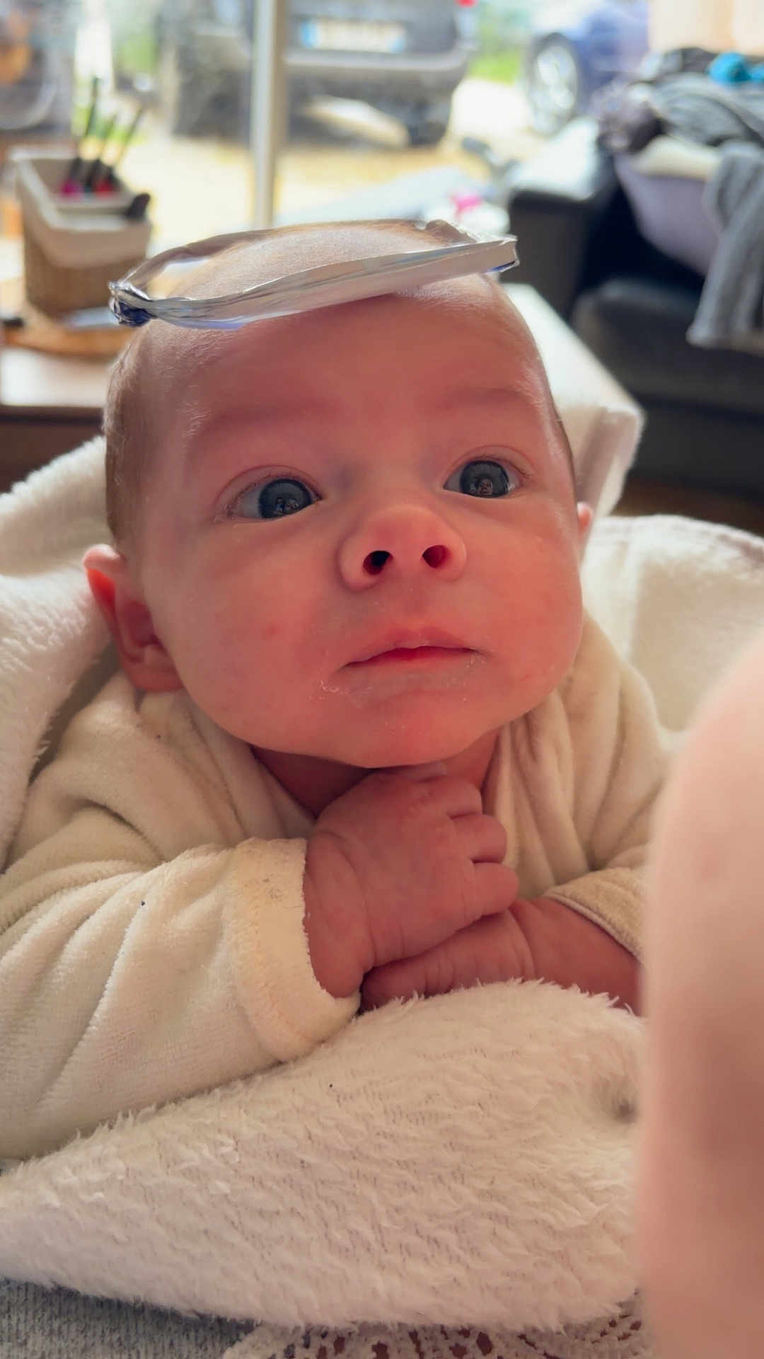 Ezio participe au concours pour gagner de l'argent avec cette photo : baby, infant, face, hands, blanket, clothing, indoor, closeup, expression, curious, skin, head, eyes, soft, cute, child, portrait, newborn, resting, cozy