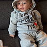 Ezio participe au concours pour gagner de l'argent avec cette photo : baby, blanket, casual_clothing, cheeks, couch, cozy, eyes, face, grey_hoodie, hand, hoodie, indoor, infant, pillow, portrait, relaxed, socks, sofa, sweatpants, young_child