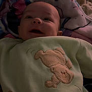 Ezio participe au concours pour gagner de l'argent avec cette photo : baby, infant, blanket, soft, smiling, face, cute, child, cozy, sleepwear, apparel, lying_down, indoors, comfort, plush, pattern, fabric, warm, head, portrait