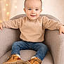 armchair, baby, blue_eyes, bokeh, boots, chair, child, cozy, cute, fair_skin, footwear, happy, indoor, jeans, lights, portrait, sitting, smiling, sweater, toddler