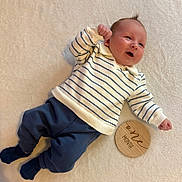 Chimmy joined the competition — help win amazing prizes! baby, infant, smile, striped_sweater, navy_pants, socks, wooden_sign, one_month, lying_down, soft_blanket, happy, cute, child, newborn, portrait, indoors, cozy, small_fists, skin, face