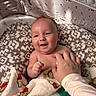 baby, infant, smile, happy, hand, blanket, crib, pattern, cute, playful, child, skin, face, indoors, comfort, cozy, person, young, expression, toddler