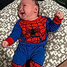 Chimmy joined the competition — help win amazing prizes! baby, infant, smiling, spiderman_costume, blue_clothing, red_clothing, patterned_cushion, cushion, lying_down, happy, child, person, indoor, cute, joyful, fist, furniture, head, face, playful