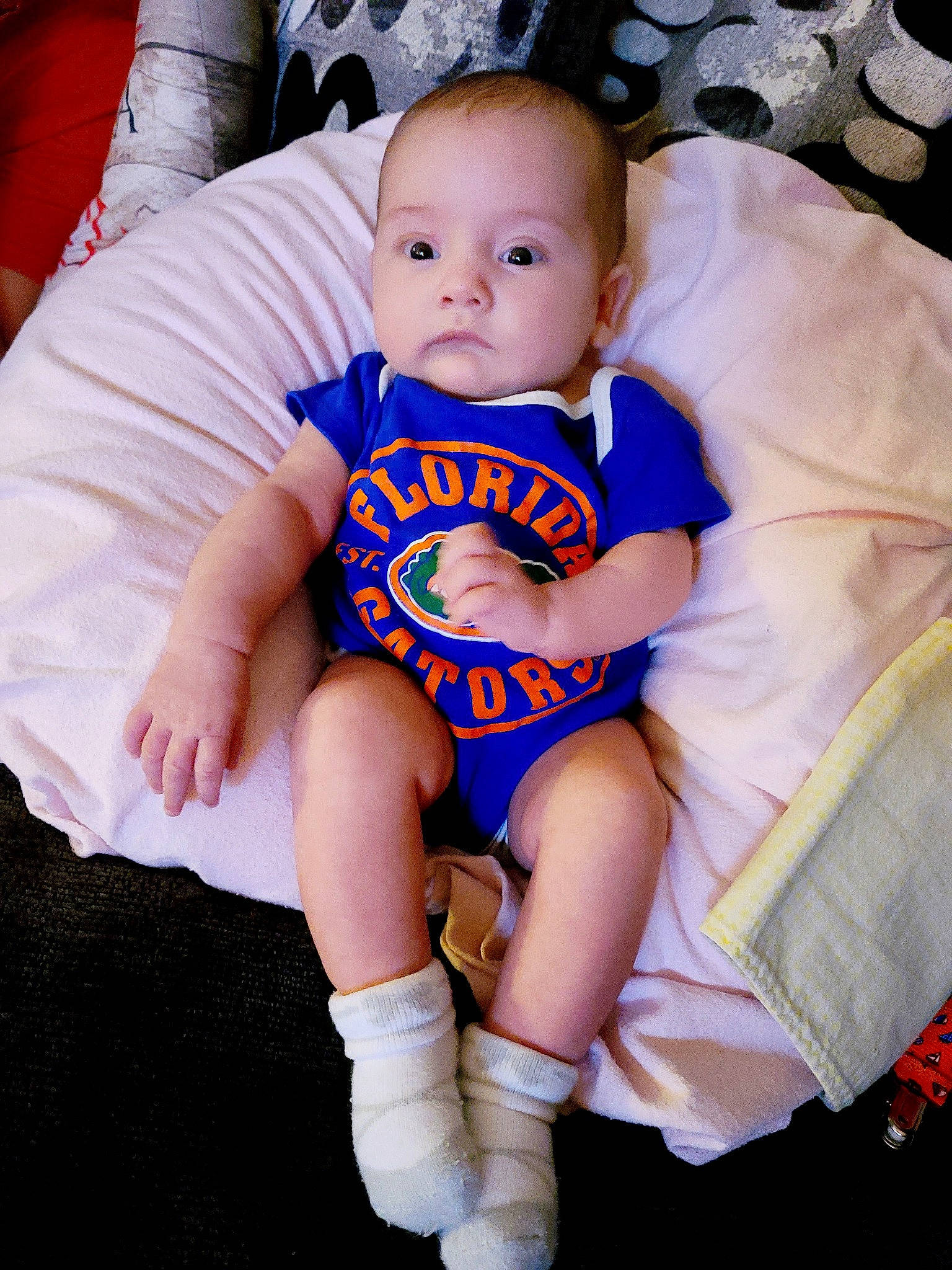 Raegan is registered to the contest to win money with this photo: baby, baby_products, baby_toddler_clothing, cheek, child, comfort, finger, iris, lap, linens, person, product, sitting, skin, sock, toddler