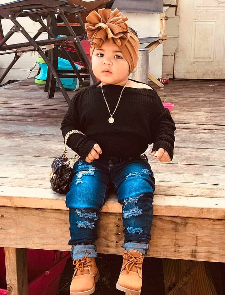 Emrys is registered to the contest to win money with this photo: denim, door, electric_blue, eyewear, fashion_design, fawn, hairstyle, headgear, headwear, human_leg, knee, leg, person, shoe, sleeve, sock, street_fashion, thigh, toy, white