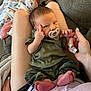 Shawn joined the competition — help win amazing prizes! baby, infant, child, pacifier, hand, fingers, feet, couch, blanket, sleeping, person, clothing, home, relaxing, nail_polish, camouflage, green_shirt, closeup, indoor, family