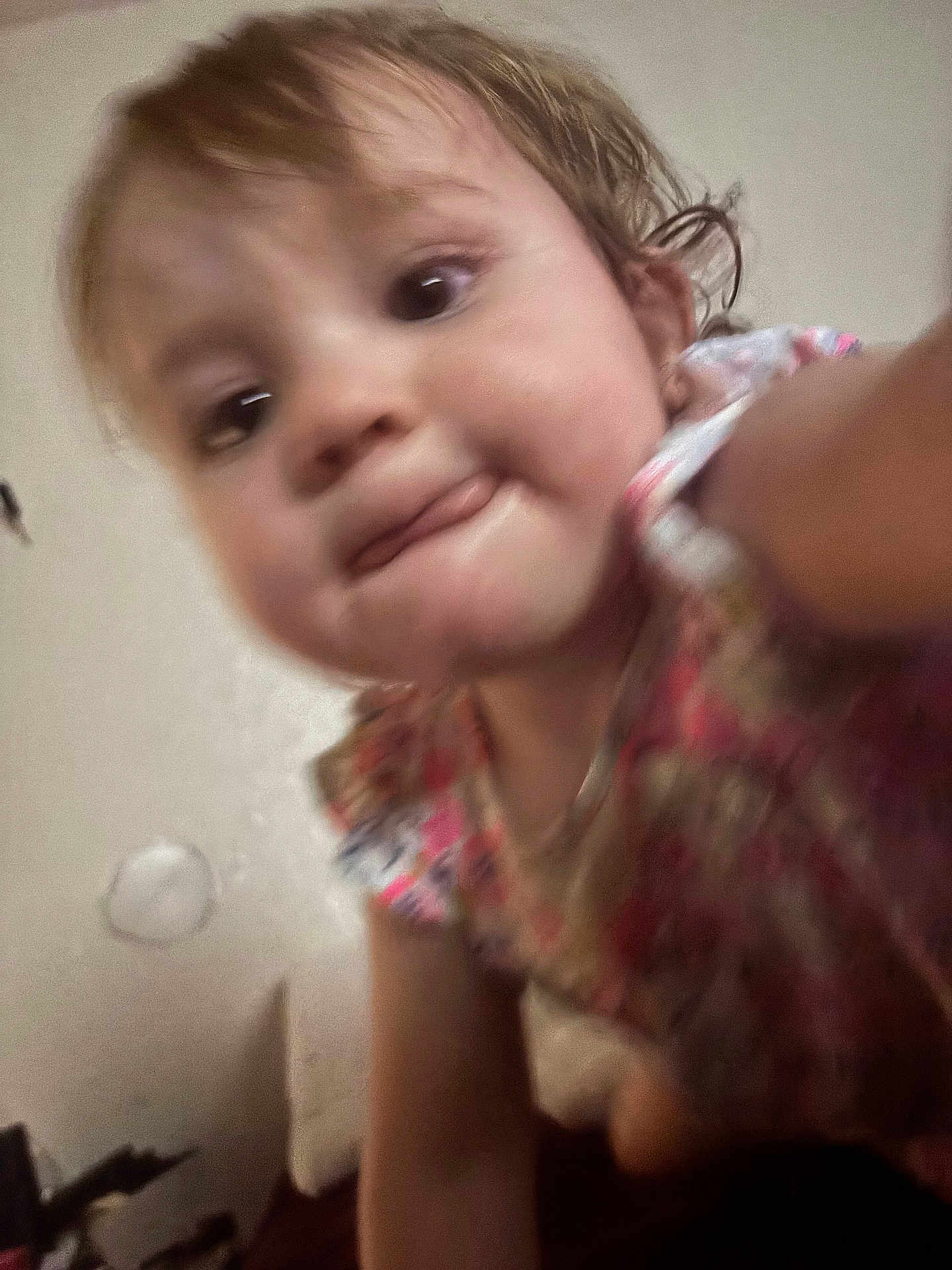 Emelia joined the competition — help win amazing prizes! child, toddler, face, tongue, closeup, blurry, indoor, colorful_clothing, curious, person, skin, hair, expression, young_child, portrait, cute, baby, head, playful, casual