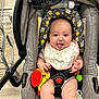 Emelia joined the competition — help win amazing prizes! baby, car_seat, bib, toy, shopping_cart, floor, playful, tongue_out, child, infant, seatbelt, gray, fabric, cute, indoor, person, smiling, plush_toy, head_support, shopping