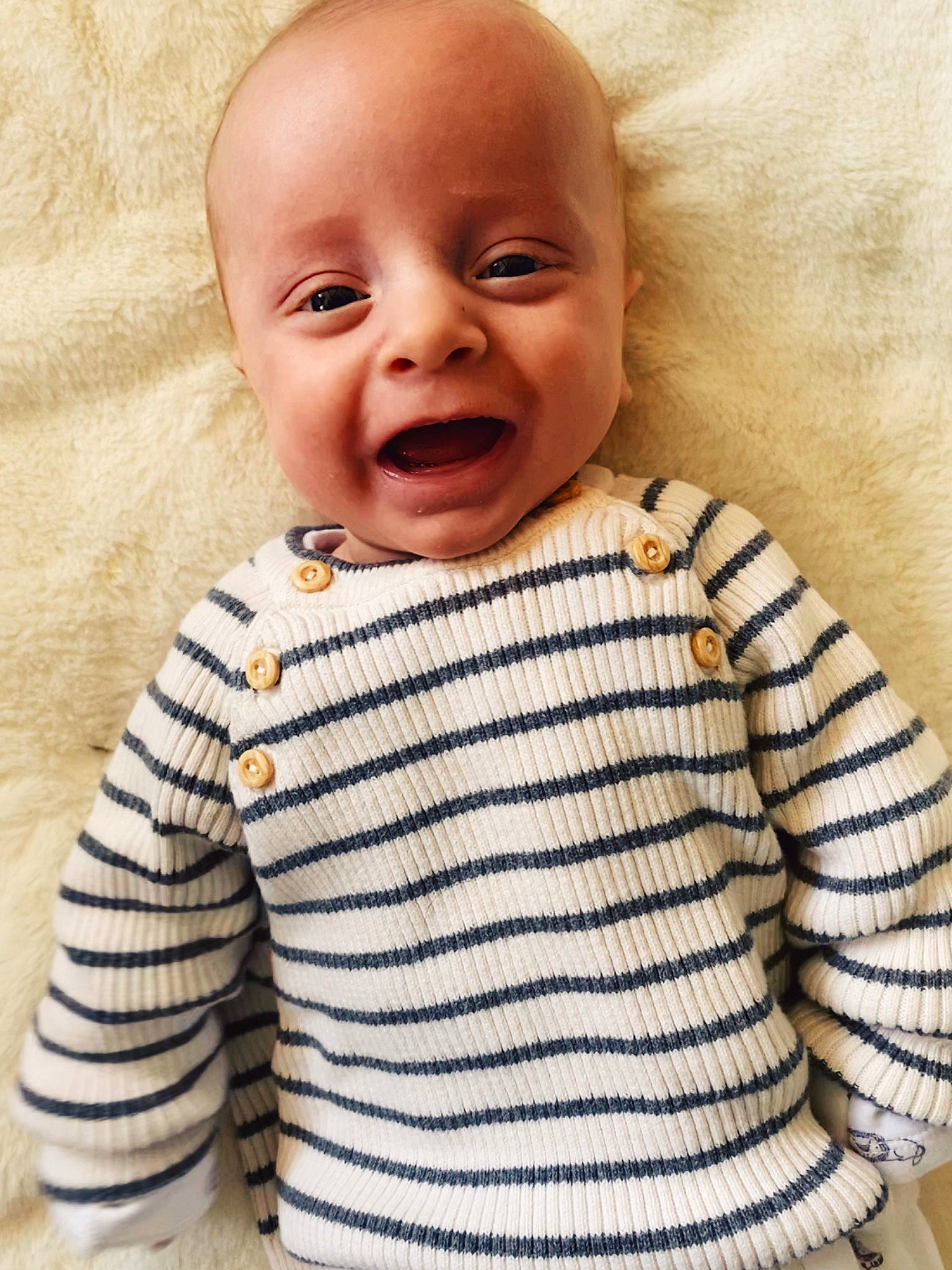 Chester is registered to the contest to win money with this photo: baby, baby_laughing, baby_toddler_clothing, cheek, child, face, facial_expression, head, knitting, lip, nose, outerwear, pattern, person, sleeve, smile, sweater, t_shirt, toddler, top