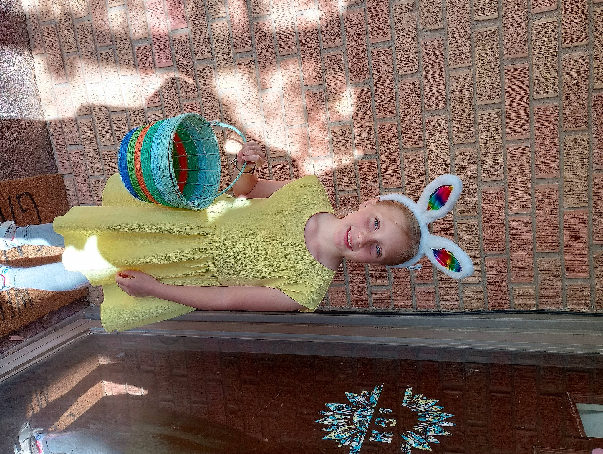 Alice is registered to the contest to win money with this photo: baby, brickwork, comfort, eyewear, fashion_accessory, fun, hat, jewellery, joy, leisure, pattern, person, sitting, sunglasses, t_shirt, toddler, visual_arts, wood