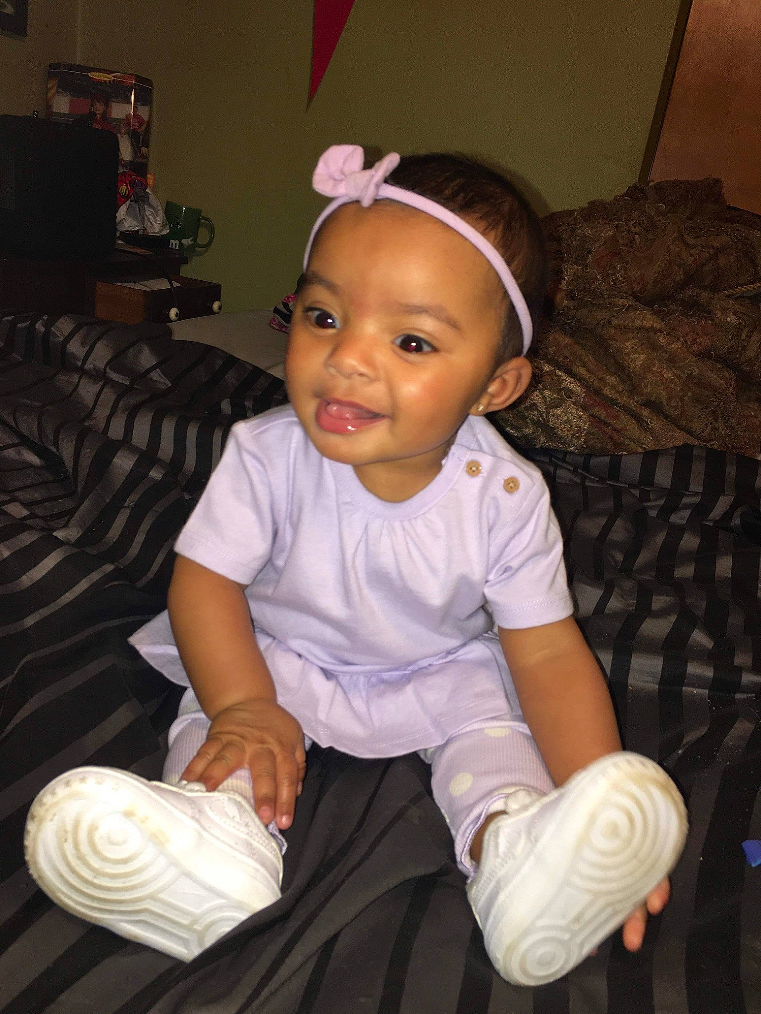 Skye is registered to the contest to win money with this photo: baby, baby_toddler_clothing, cheek, child, comfort, elbow, flash_photography, fun, happy, headband, human_body, iris, lap, person, room, sitting, skin, sleeve, smile, thumb