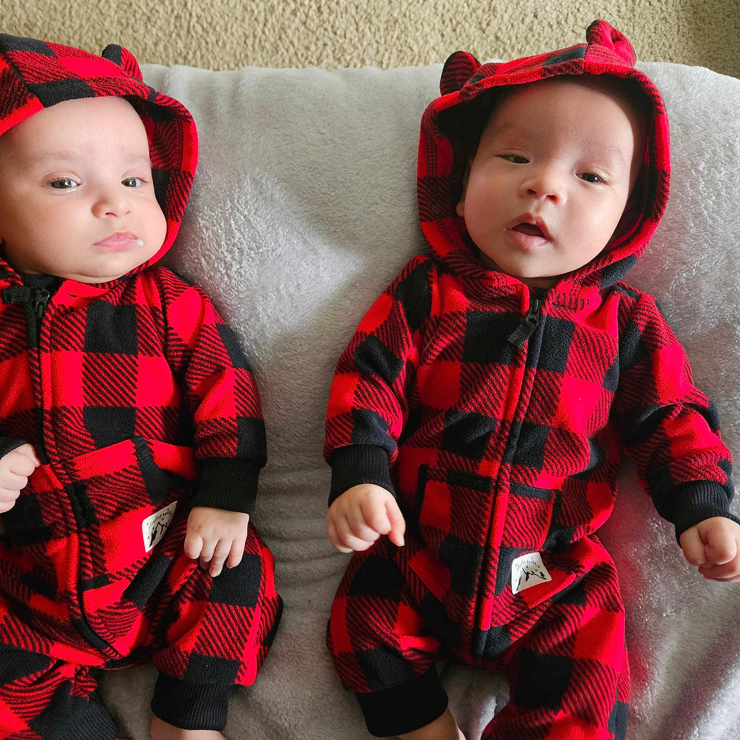 Elijah And Elias is registered to the contest to win money with this photo: baby, blanket, bonnet, cap, clothing, coat, couch, face, furniture, hat, head, hood, hoodie, jacket, knitwear, person, photography, portrait, sweater, sweatshirt