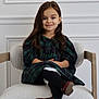 Mia is registered to the contest to win money with this photo: child, girl, smile, dress, plaid, long_hair, chair, crossed_legs, red_shoes, black_tights, indoor, portrait, young, cute, happy, sitting, elegant, minimalist, cozy, fashion