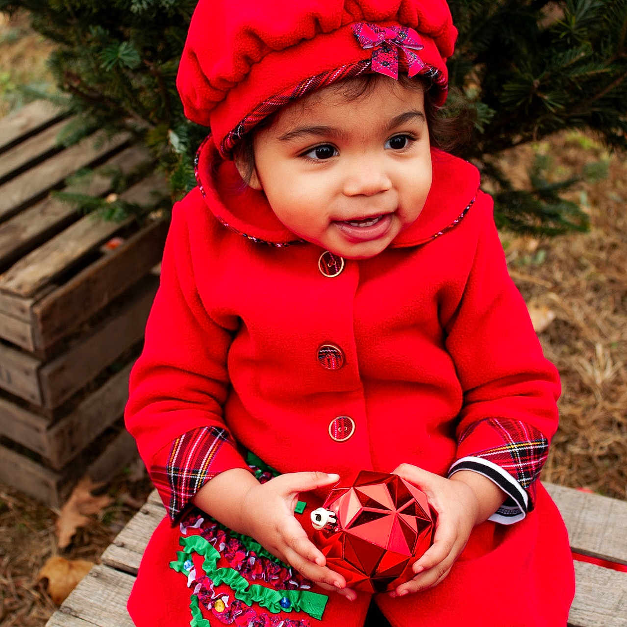 Yemaya is registered to the contest to win money with this photo: baby, bonnet, cap, clothing, coat, dress, face, hat, head, hood, hoodie, jacket, knitwear, person, photography, plant, portrait, sweater, sweatshirt, tree