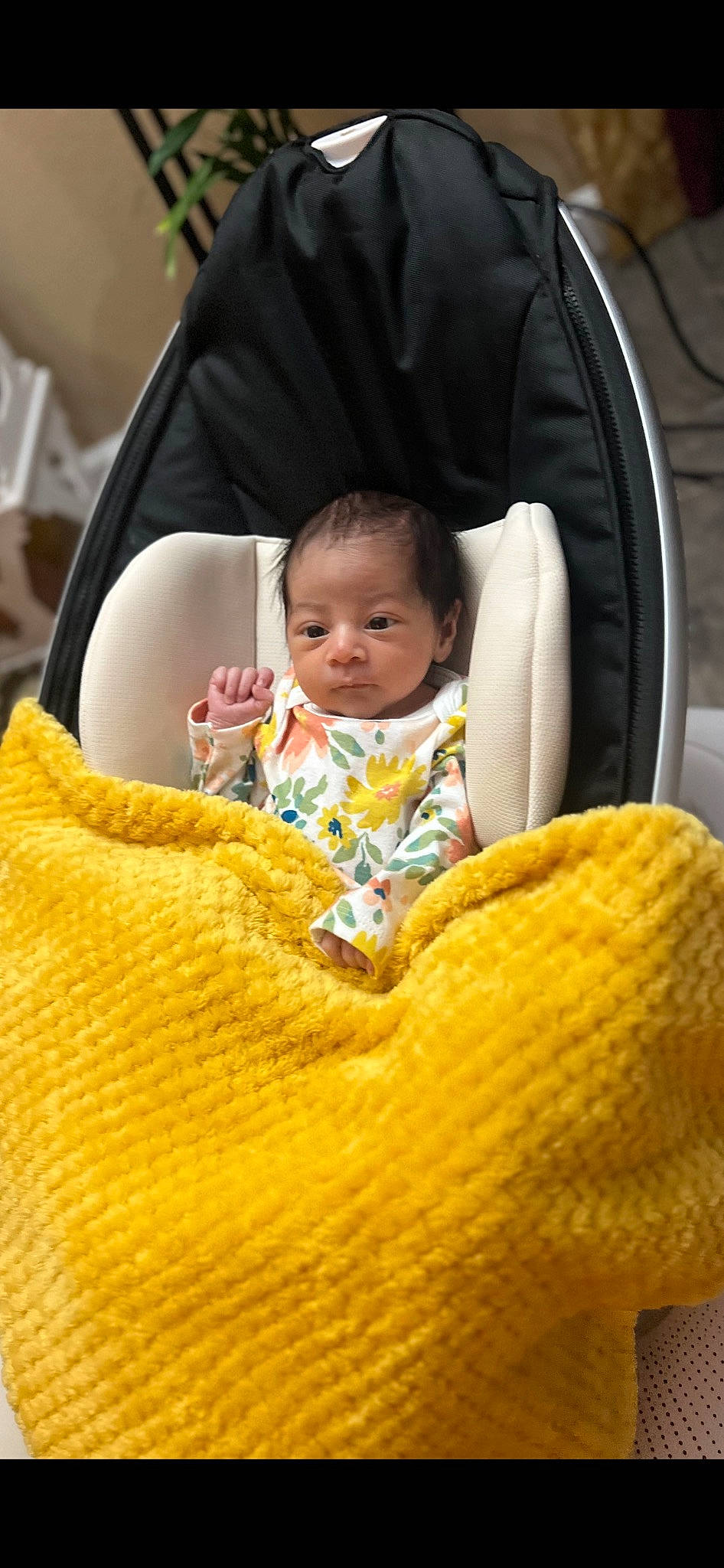 Elsa is registered to the contest to win money with this photo: baby, baby_products, baby_toddler_clothing, car_seat, chair, child, comfort, eye, flooring, hand, lap, linens, outerwear, person, plant, product, pumpkin, stuffed_toy, textile, toddler