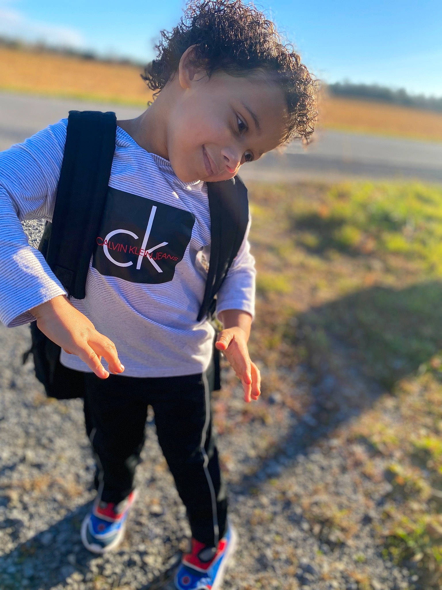 Matteo is registered to the contest to win money with this photo: child, electric_blue, fun, grass, grassland, happy, joy, landscape, leisure, people_in_nature, person, personal_protective_equipment, play, recreation, sand, sky, sleeve, soil, sportswear, t_shirt