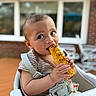 toddler, child, corn, grilled_corn, high_chair, outdoor, food, eating, baby, face, expression, summer, window, patio, furniture, clothing, striped_shirt, hands, closeup, portrait