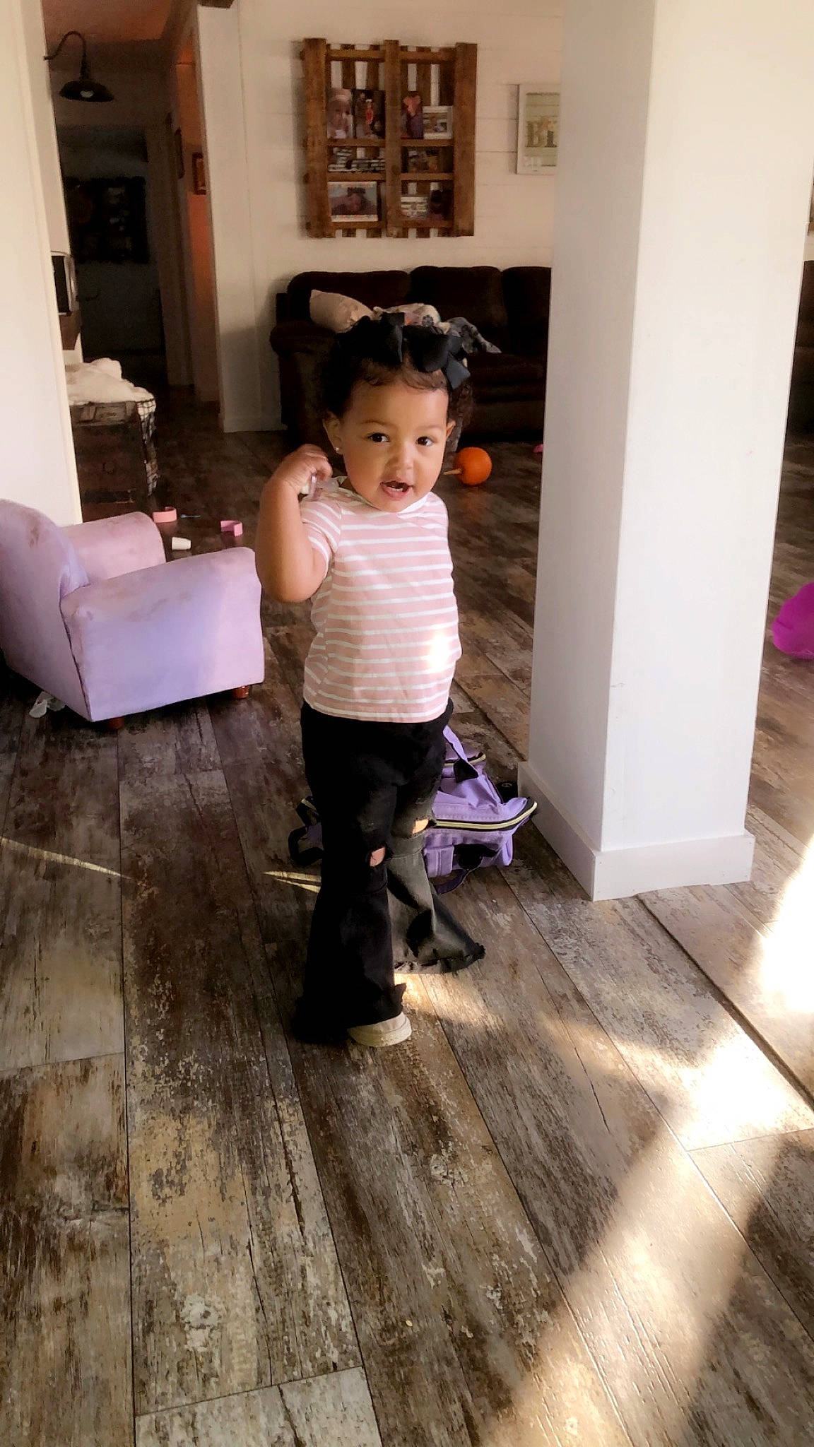 Haizley is registered to the contest to win money with this photo: child, door, floor, flooring, fun, happy, hardwood, home_door, laminate_flooring, living_room, pattern, person, room, sitting, standing, toddler, varnish, waist, wood, wood_flooring