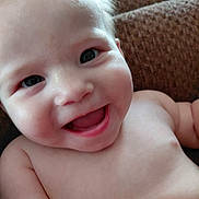 Arianna is registered to the contest to win money with this photo: baby, smiling, closeup, face, skin, hand, happy, infant, child, portrait, bare_chest, human, cute, expression, young, background, texture, flesh, person, joy