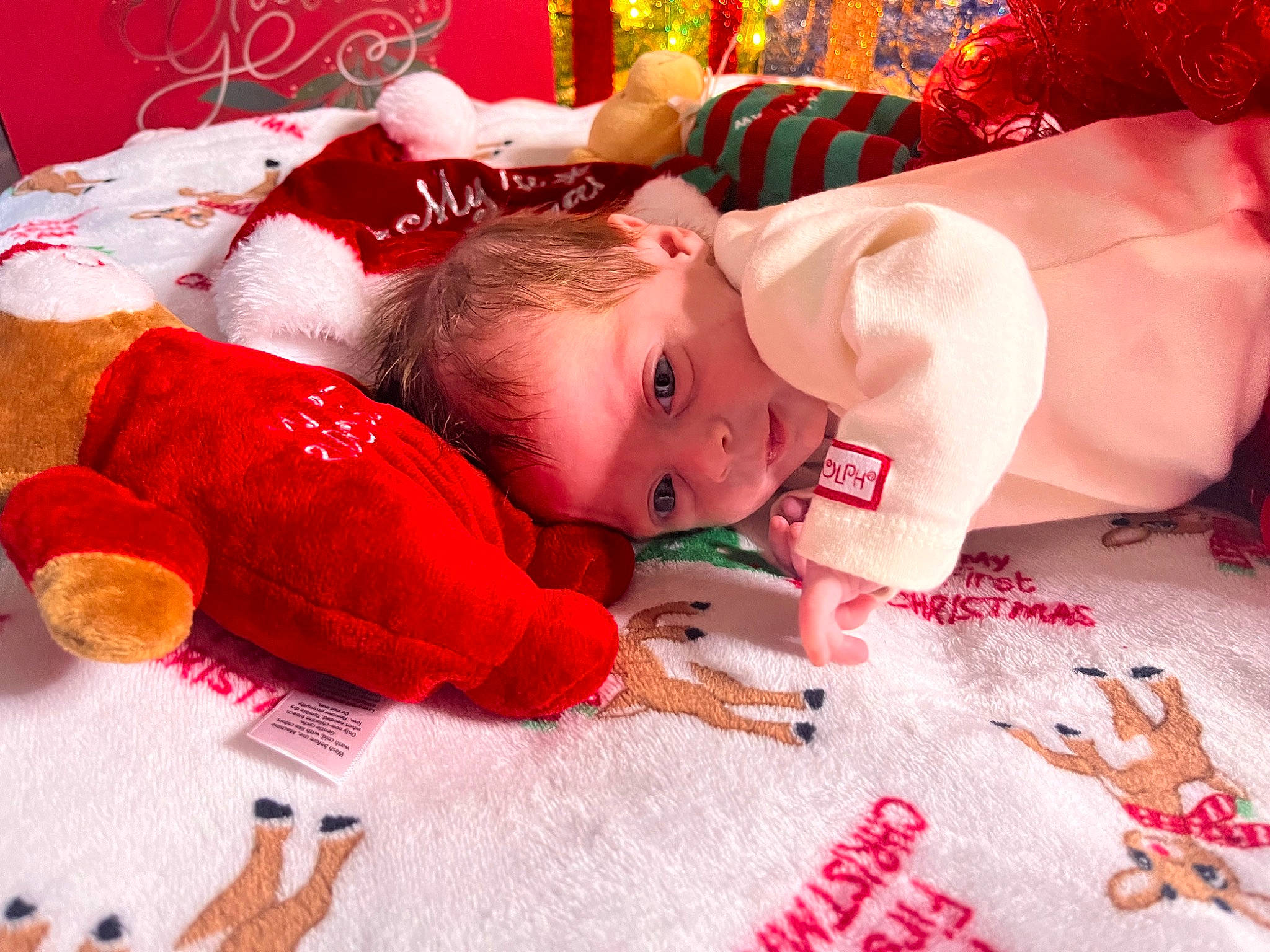 Rosalina is registered to the contest to win money with this photo: baby, baby_toddler_clothing, carmine, child, christmas, christmas_eve, comfort, event, eye, face, fictional_character, fun, happy, holiday, linens, pattern, person, red, sleeve, sock