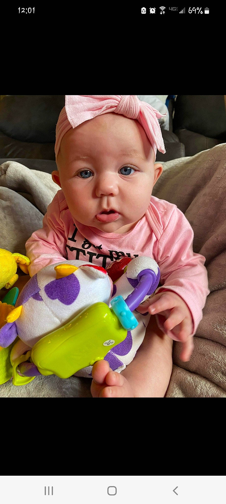 Dakoda is registered to the contest to win money with this photo: baby, baby_toddler_clothing, cap, cheek, ear, eye, eyelash, face, facial_expression, finger, hand, happy, head, iris, mouth, nose, person, purple, skin, textile